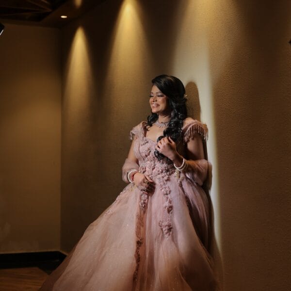 Umax Studios pre-wedding photoshoot of bride in elegant pink dress.
