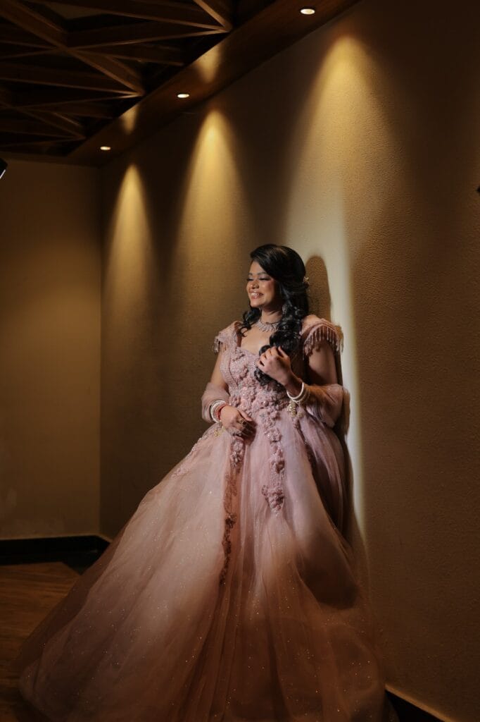 Umax Studios pre-wedding photoshoot of bride in elegant pink dress.