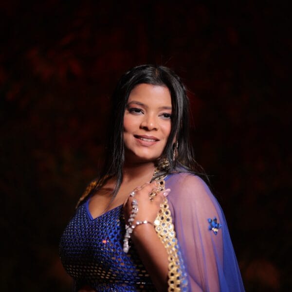 Woman posing in blue traditional outfit.