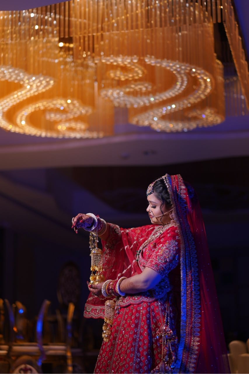 A traditionally dressed bride posing with her kalire.